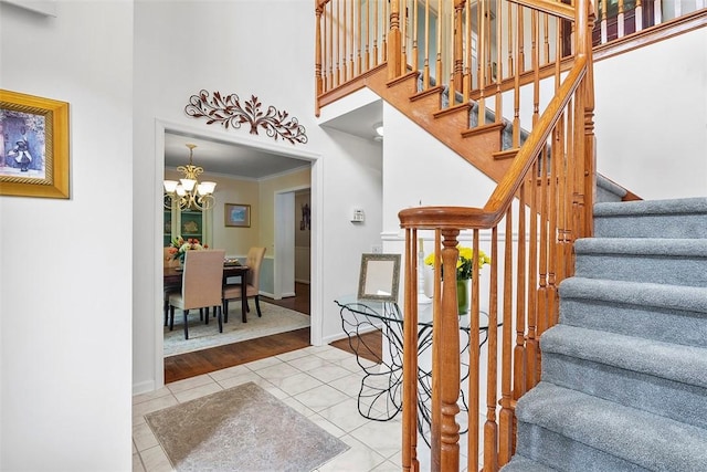 1544 Eldorado Dr, Hopewell Twp, PA 15001 - stairs featuring a chandelier, a high ceiling, tile patterned floors, and crown molding