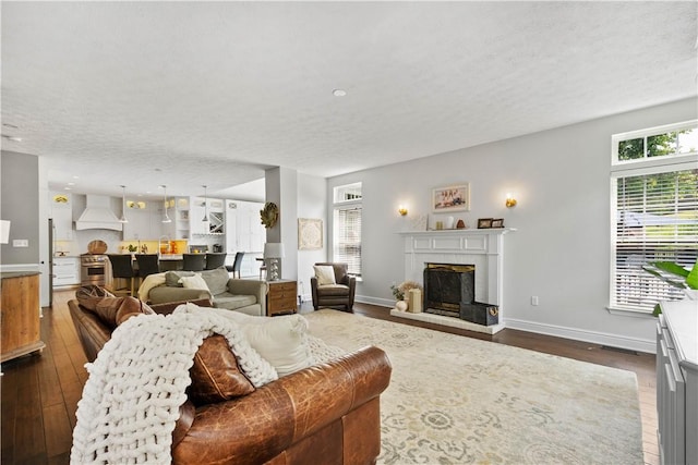 237 Clever Rd, Robinson Twp, PA 15136 - living area featuring dark wood-type flooring, a fireplace with raised hearth, and a textured ceiling
