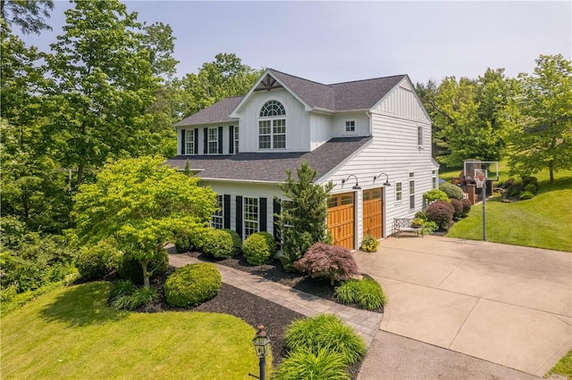 237 Clever Rd, Robinson Twp, PA 15136 - view of front of property featuring concrete driveway, board and batten siding, a front lawn, a shingled roof, and an attached garage