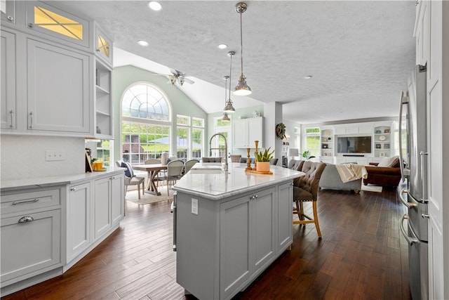 237 Clever Rd, Robinson Twp, PA 15136 - kitchen featuring open floor plan, dark wood-style floors, lofted ceiling, an island with sink, and white cabinetry