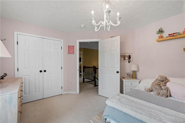 237 Clever Rd, Robinson Twp, PA 15136 - bedroom featuring a chandelier, light colored carpet, a closet, and a textured ceiling