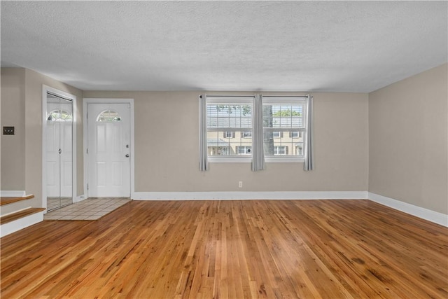 109 Raleigh Ct, Ross Twp, PA 15237 - entryway with light wood finished floors, a textured ceiling, and stairway