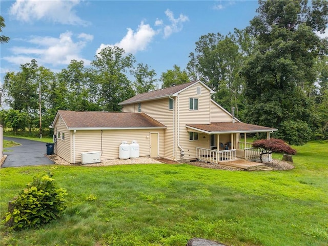110 Four Seasons Ln, Irwin, PA 15642 - rear view of property featuring a lawn, covered porch, roof with shingles, and view of scattered trees