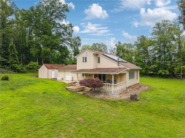110 Four Seasons Ln, Irwin, PA 15642 - back of property featuring a shed, solar panels, a lawn, and a porch