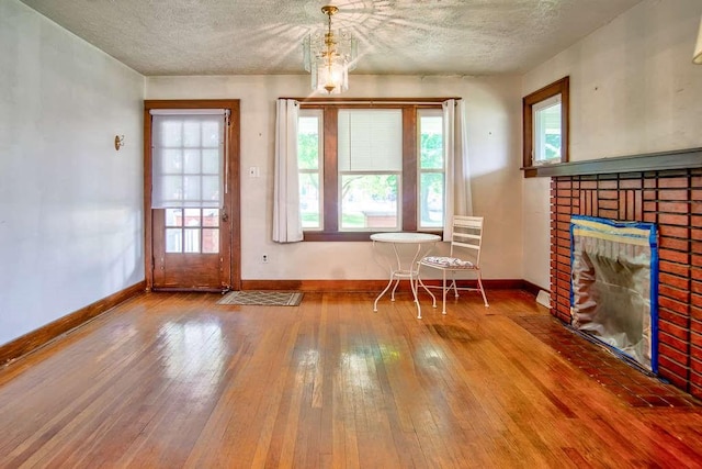3444 Brodhead Rd, Center Twp, PA 15061 - dining space with wood-type flooring, a textured ceiling, and a fireplace