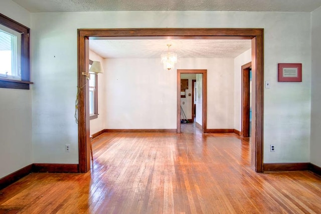 3444 Brodhead Rd, Center Twp, PA 15061 - unfurnished room featuring wood finished floors and a chandelier