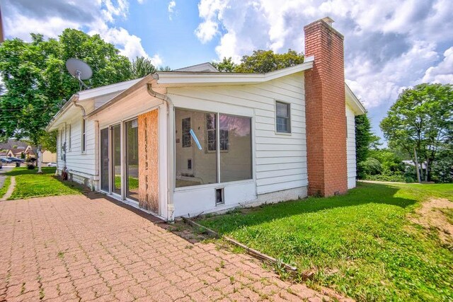3444 Brodhead Rd, Center Twp, PA 15061 - view of side of property with a chimney, a sunroom, and a lawn