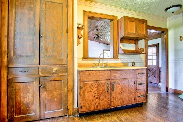 3444 Brodhead Rd, Center Twp, PA 15061 - kitchen with dark wood-type flooring, light countertops, brown cabinets, and ornamental molding
