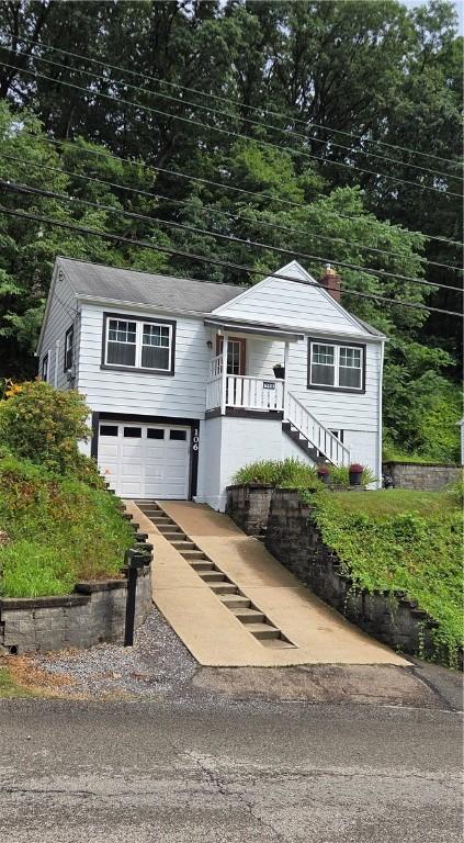 106 6th Ave, Ross Twp, PA 15229 - view of front of house featuring driveway, an attached garage, stairway, covered porch, and a chimney