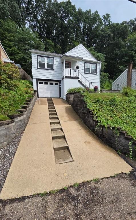 106 6th Ave, Ross Twp, PA 15229 - view of front of house featuring stairway, driveway, and an attached garage