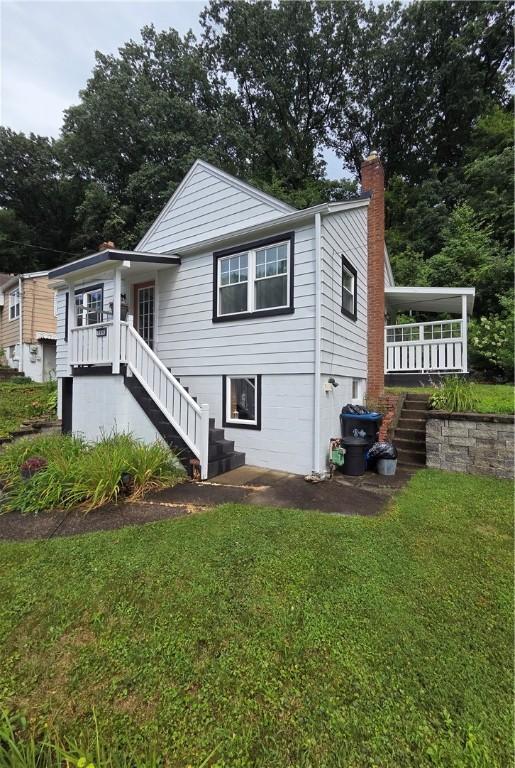 106 6th Ave, Ross Twp, PA 15229 - view of front of property with stairway, a front yard, and a chimney