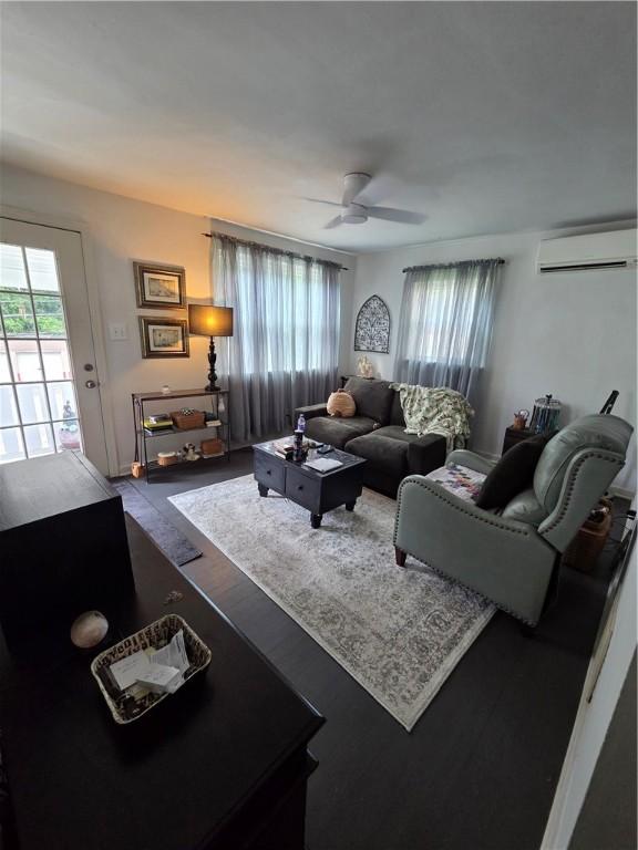 106 6th Ave, Ross Twp, PA 15229 - living room with an AC wall unit, ceiling fan, and wood finished floors