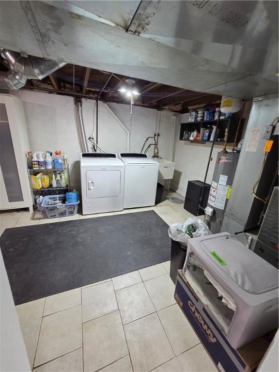 106 6th Ave, Ross Twp, PA 15229 - unfinished below grade area featuring water heater, independent washer and dryer, and tile patterned flooring