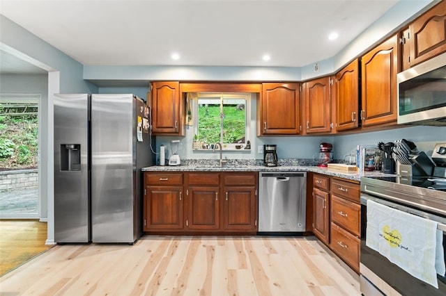 4 Thornridge Rd, Kilbuck Twp, PA 15202 - kitchen featuring stainless steel appliances, light wood finished floors, brown cabinets, light stone counters, and recessed lighting