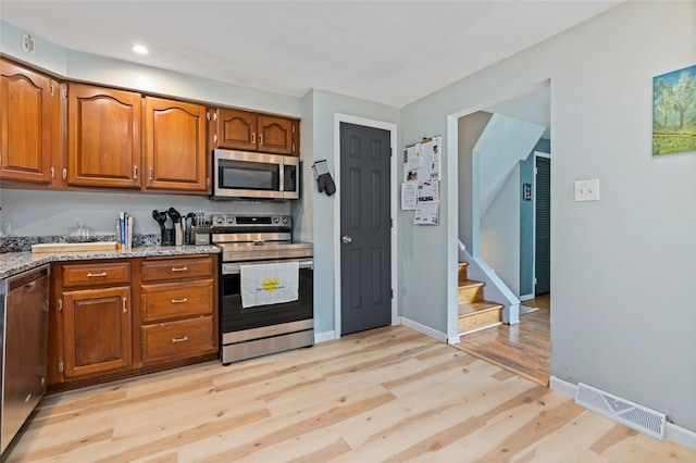 4 Thornridge Rd, Kilbuck Twp, PA 15202 - kitchen with appliances with stainless steel finishes, light wood-type flooring, brown cabinetry, light stone counters, and recessed lighting