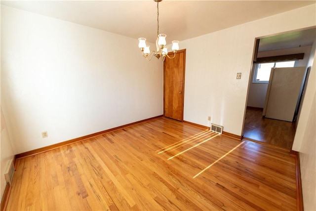 1819 Sundeman St, Troy Hill, PA 15212 - unfurnished room featuring a chandelier and light wood-type flooring