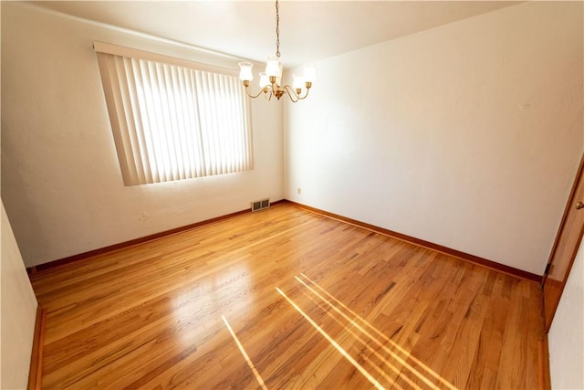 1819 Sundeman St, Troy Hill, PA 15212 - empty room featuring a chandelier and light wood finished floors