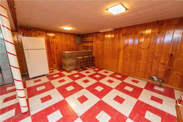 1819 Sundeman St, Troy Hill, PA 15212 - finished below grade area with freestanding refrigerator, light flooring, a bar, wooden walls, and electric panel