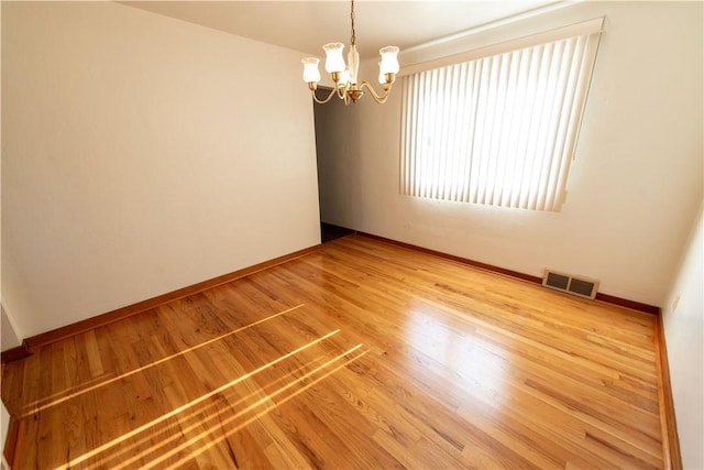1819 Sundeman St, Troy Hill, PA 15212 - empty room with a chandelier and light wood-type flooring