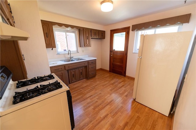 1819 Sundeman St, Troy Hill, PA 15212 - kitchen featuring white appliances, under cabinet range hood, light countertops, and light wood-style floors
