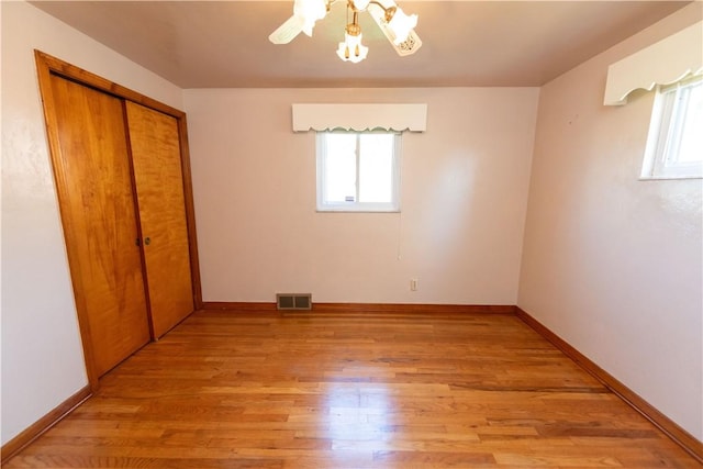 1819 Sundeman St, Troy Hill, PA 15212 - unfurnished bedroom with multiple windows, light wood-style flooring, a closet, and ceiling fan