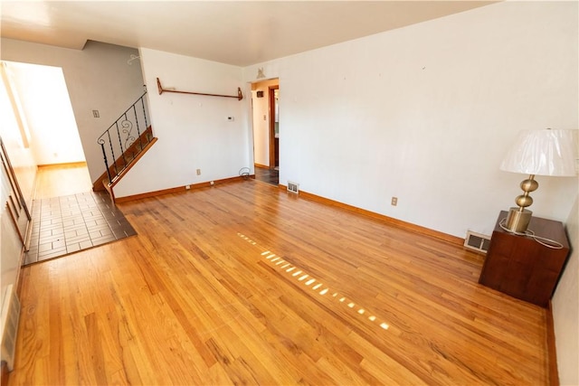 1819 Sundeman St, Troy Hill, PA 15212 - unfurnished living room with stairs and light wood-type flooring