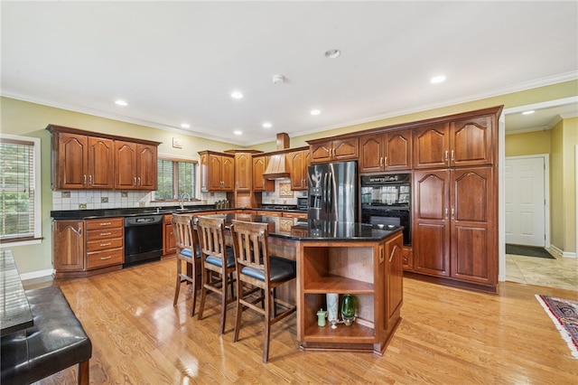 14 Amy Way S, Union Twp, PA 15401 - kitchen featuring black appliances, a center island, light wood-style flooring, backsplash, and ornamental molding