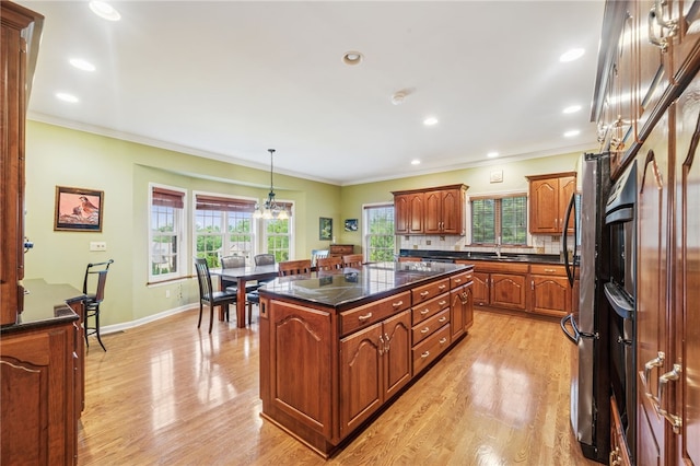 14 Amy Way S, Union Twp, PA 15401 - kitchen featuring light wood-type flooring, ornamental molding, brown cabinets, decorative light fixtures, and a center island