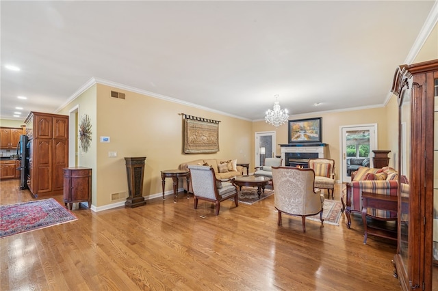 14 Amy Way S, Union Twp, PA 15401 - living room featuring light wood-style floors, a lit fireplace, a chandelier, and ornamental molding