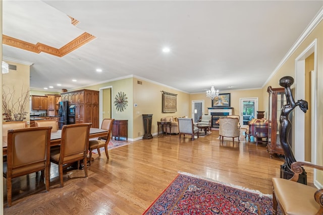 14 Amy Way S, Union Twp, PA 15401 - dining room featuring light wood finished floors, crown molding, recessed lighting, a chandelier, and a warm lit fireplace
