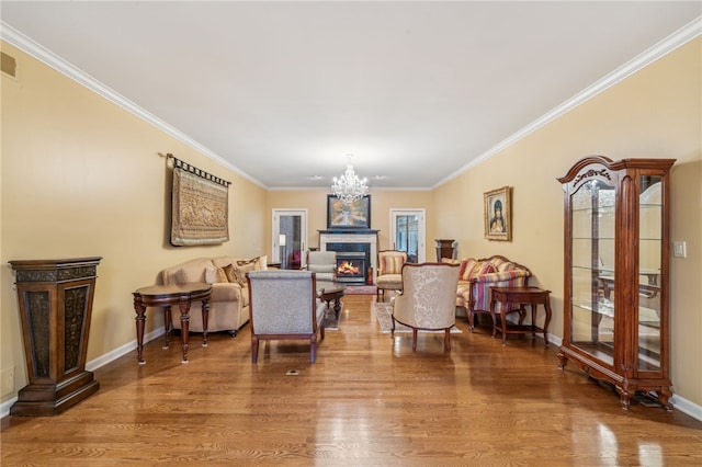 14 Amy Way S, Union Twp, PA 15401 - living area featuring wood finished floors, a chandelier, a warm lit fireplace, and crown molding
