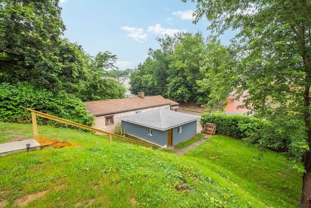 1819 Craig St, Mckeesport, PA 15132 - back of house with a yard, a shingled roof, and a chimney
