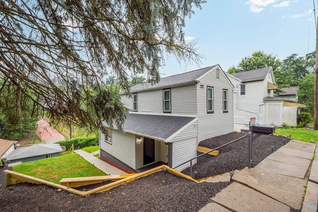 1819 Craig St, Mckeesport, PA 15132 - view of front facade featuring a shingled roof, a front lawn, and a shed