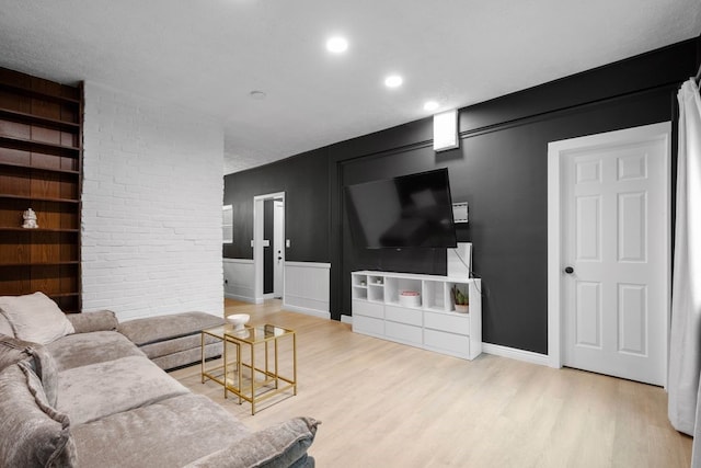 1819 Craig St, Mckeesport, PA 15132 - living area featuring wood finished floors, a decorative wall, and recessed lighting
