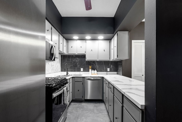 1819 Craig St, Mckeesport, PA 15132 - kitchen with appliances with stainless steel finishes, gray cabinets, decorative backsplash, and light stone countertops