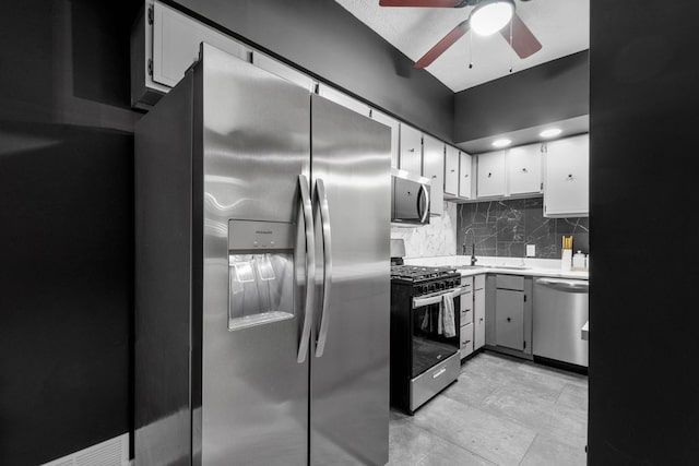 1819 Craig St, Mckeesport, PA 15132 - kitchen featuring stainless steel appliances, a ceiling fan, tasteful backsplash, and white cabinets