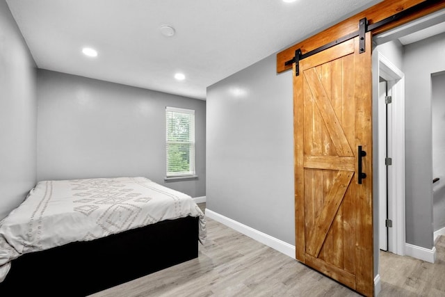1819 Craig St, Mckeesport, PA 15132 - bedroom with a barn door, light wood-style floors, and recessed lighting