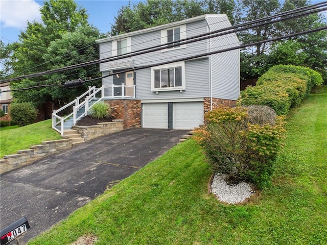 2047 Haymaker Rd, Monroeville, PA 15146 - view of front of property featuring an attached garage, asphalt driveway, a front lawn, brick siding, and stairs