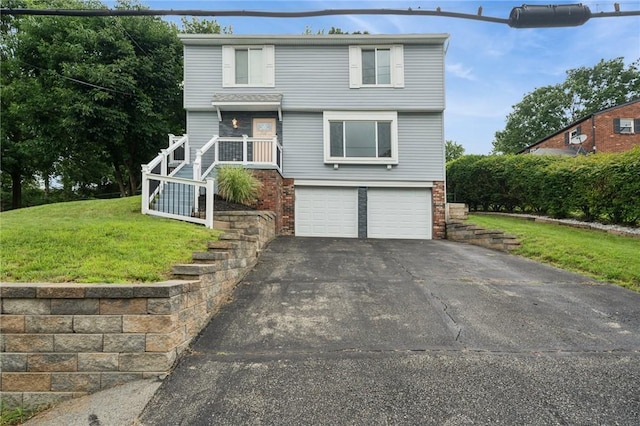 2047 Haymaker Rd, Monroeville, PA 15146 - view of front facade with an attached garage, asphalt driveway, brick siding, and a front lawn