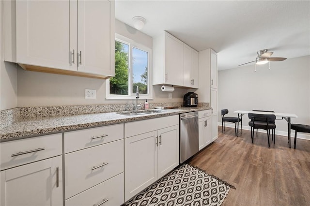 2047 Haymaker Rd, Monroeville, PA 15146 - kitchen featuring stainless steel dishwasher, white cabinetry, wood finished floors, a ceiling fan, and light stone countertops