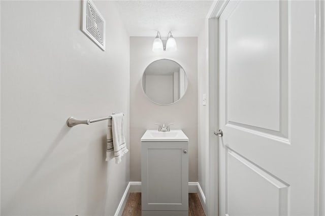 2047 Haymaker Rd, Monroeville, PA 15146 - bathroom with vanity, a textured ceiling, and wood finished floors