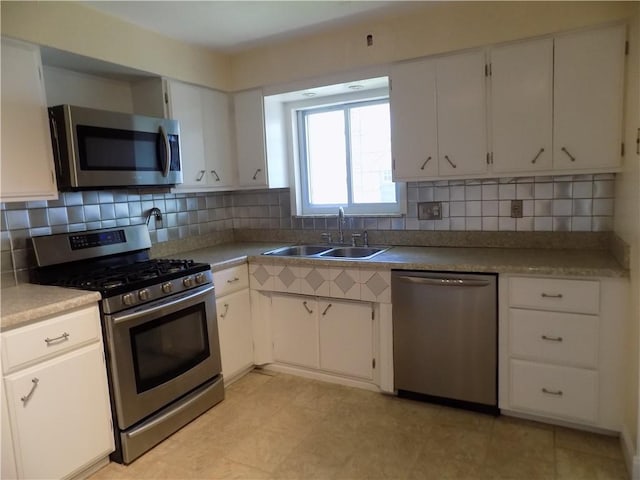 3055 Fadette St, Sheraden, PA 15204 - kitchen featuring stainless steel appliances, tasteful backsplash, and white cabinets