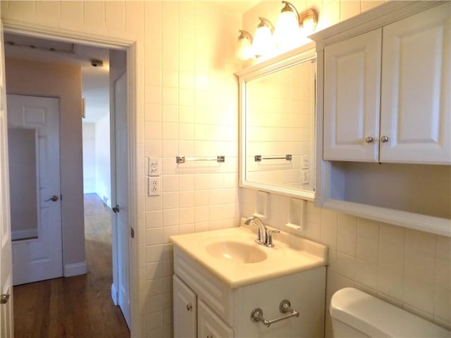 3055 Fadette St, Sheraden, PA 15204 - bathroom featuring tile walls, vanity, backsplash, and wood finished floors