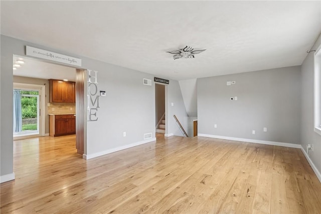 1717 Gina Dr, West Mifflin, PA 15122 - unfurnished living room featuring light wood finished floors and stairs