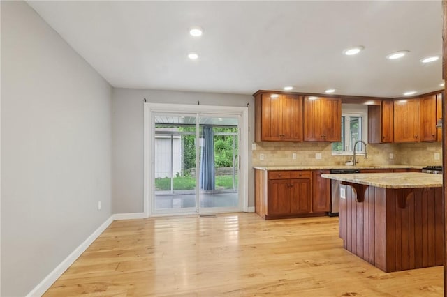 1717 Gina Dr, West Mifflin, PA 15122 - kitchen with stainless steel dishwasher, tasteful backsplash, plenty of natural light, light wood-style floors, and recessed lighting
