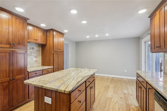 1717 Gina Dr, West Mifflin, PA 15122 - kitchen with dishwashing machine, light wood-style flooring, decorative backsplash, recessed lighting, and light stone counters
