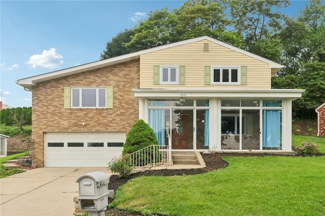 1717 Gina Dr, West Mifflin, PA 15122 - view of front of house with an attached garage, concrete driveway, brick siding, a front yard, and a sunroom