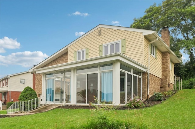 1717 Gina Dr, West Mifflin, PA 15122 - rear view of property with brick siding, a chimney, a sunroom, and a lawn