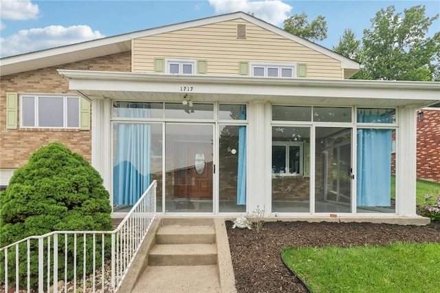 1717 Gina Dr, West Mifflin, PA 15122 - rear view of property with a sunroom and brick siding