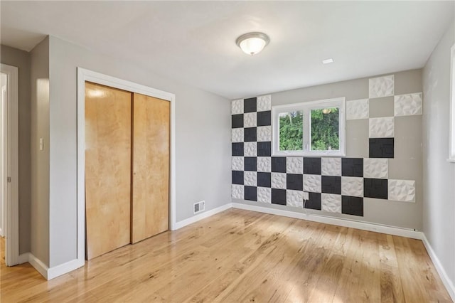 1717 Gina Dr, West Mifflin, PA 15122 - unfurnished bedroom featuring hardwood / wood-style floors and a closet